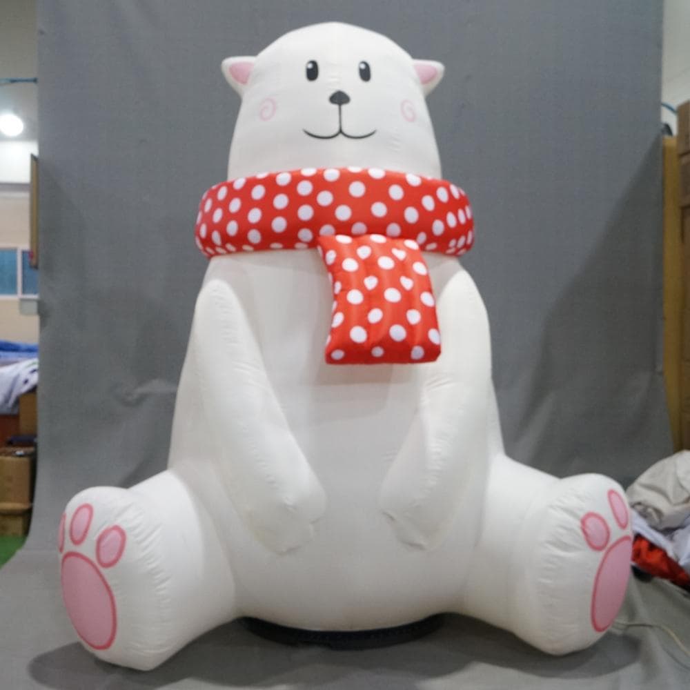 Polar bear wearing a red dot pattern scarf inflatable